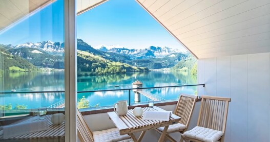 Cafe table on a balcony overlooking lake and mountains in Switzerland