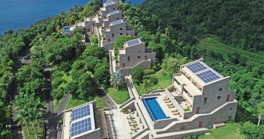 An aerial view of Coulibri Ridge, with solar panels, pool, and deck visible 