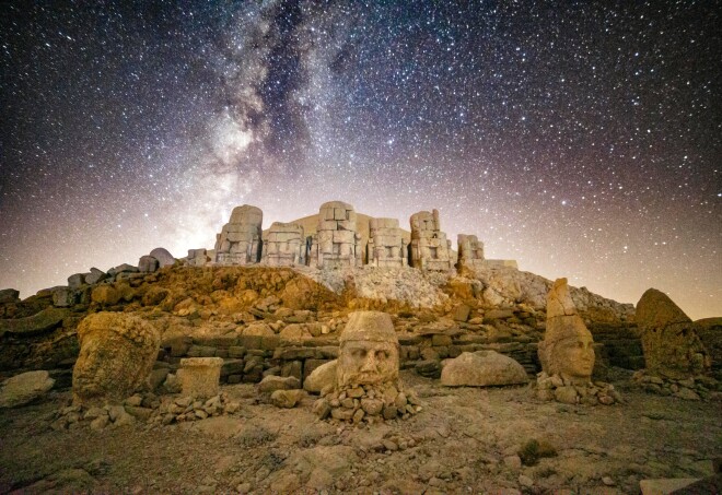 Ancient Mesopotamian statues by starlight on Nemrut Mountain, Türkiye