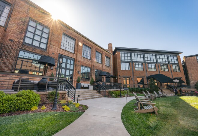 The brick exterior and lawn of the Foundry Hotel in Asheville, North Carolina